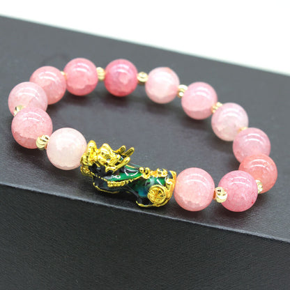 Pink color-changing Pixiu bracelet with synthetic thermochromic beads in varying shades and gold-plated cloisonné enamel Pixiu featuring green and black colors