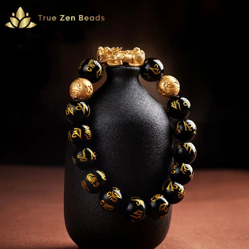 Close-up of 12mm black obsidian beads paired with matte gold accents for balanced energy flow
