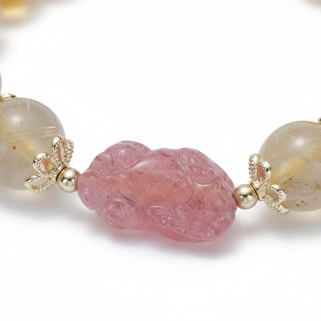 Close-up of hand-carved Pixiu charm in pink rose quartz showing artisan detail and craftsmanship