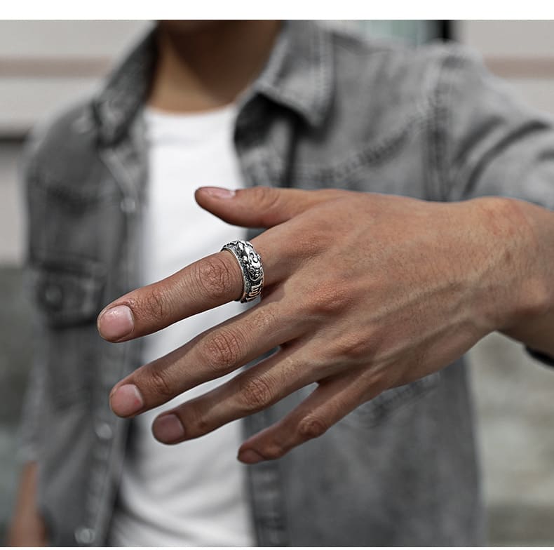 Person wearing a hand-carved Pixiu ring on the middle finger, showcasing the adjustable fit and dimensional design.