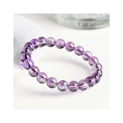 Purple quartz bracelet arranged in a bright studio setting with translucent violet beads