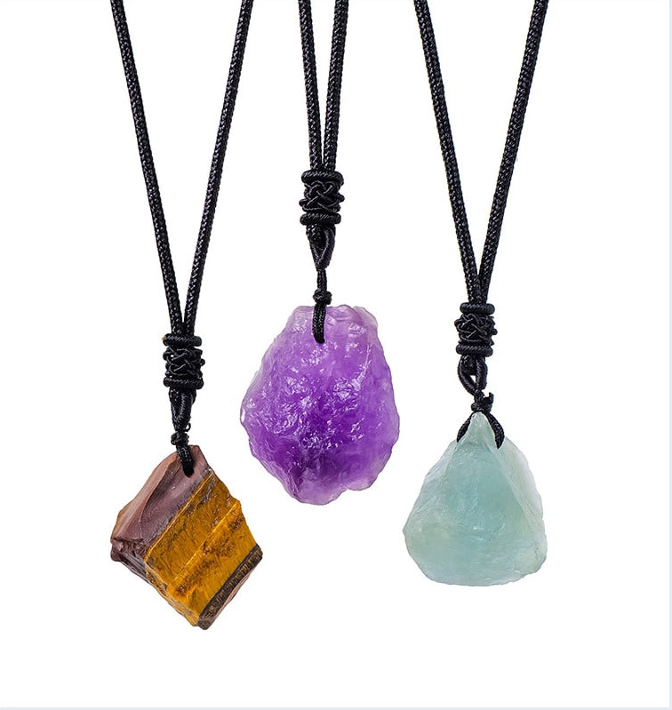 Three raw crystal stone pendant necklaces on white background