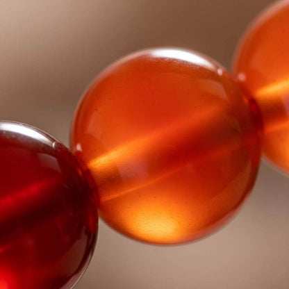 Close-up of Red Agate beads showing vitreous luster and natural banding patterns