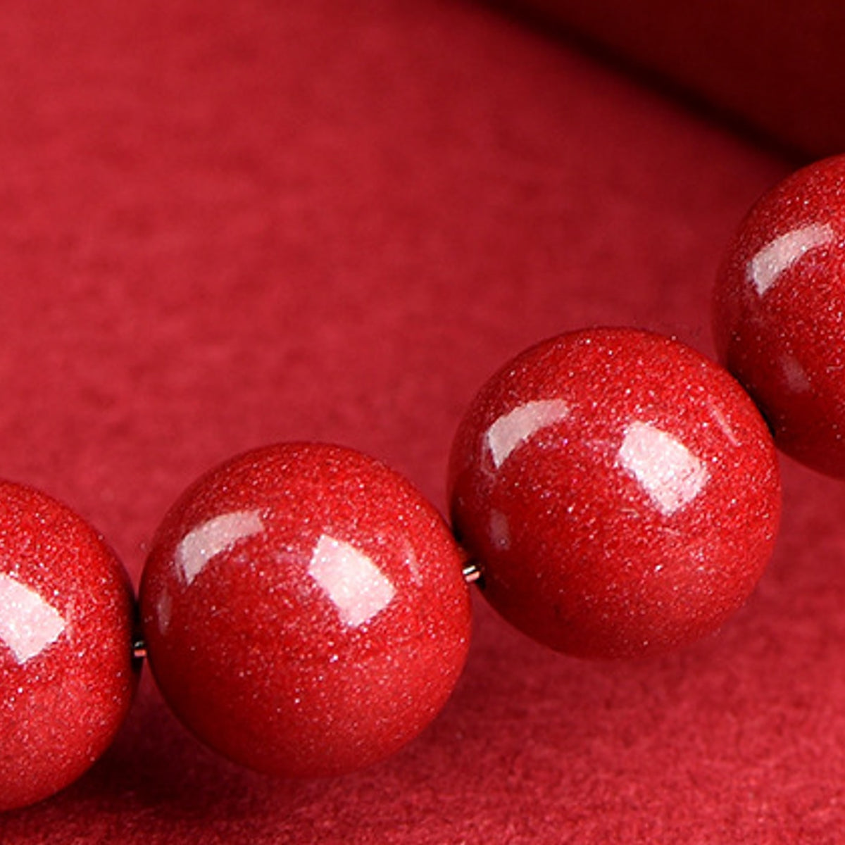 Close up of glossy red cinnabar style bracelet beads