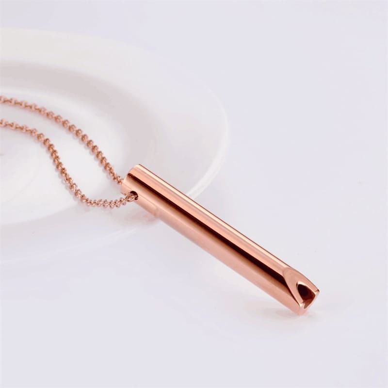 Rose gold whistle pendant featuring mirror polish craftsmanship on stainless steel base showing reflective surface and premium finish quality.