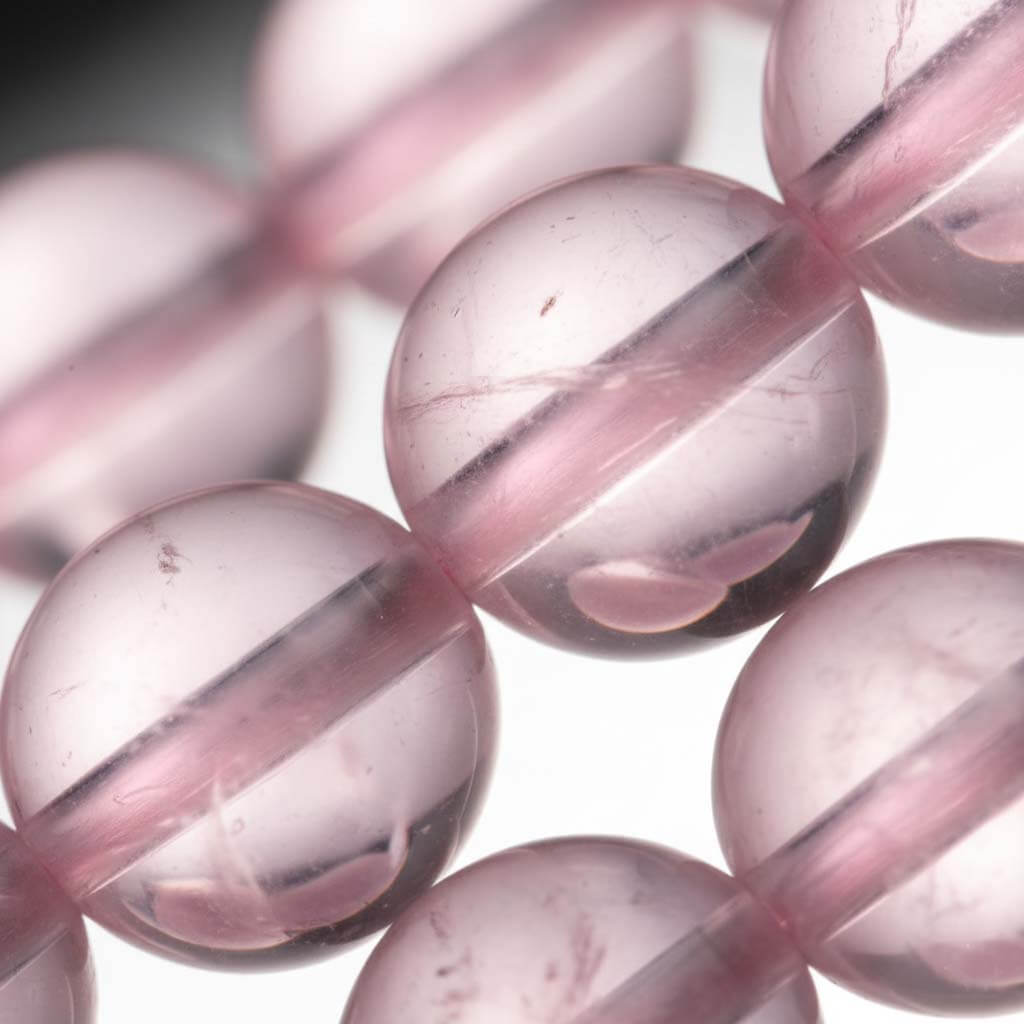 Close-up of Rose Quartz beads showing translucent clarity and AAA grade quality