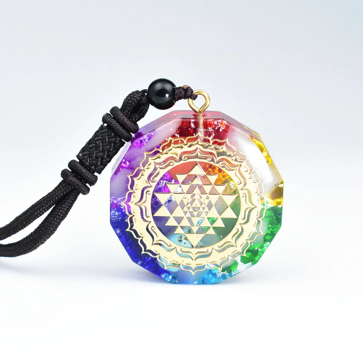 Seven-color layered resin pendant with golden Sri Yantra sacred geometry pattern and rainbow gradient