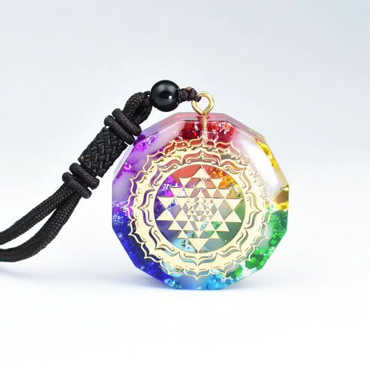 Seven-color layered resin pendant with golden Sri Yantra sacred geometry pattern and rainbow gradient