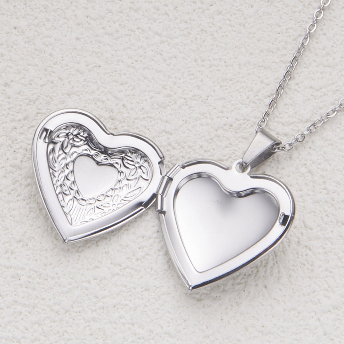 Silver heart locket necklace opened to show photo compartment