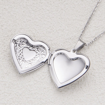 Silver heart locket necklace opened to show photo compartment