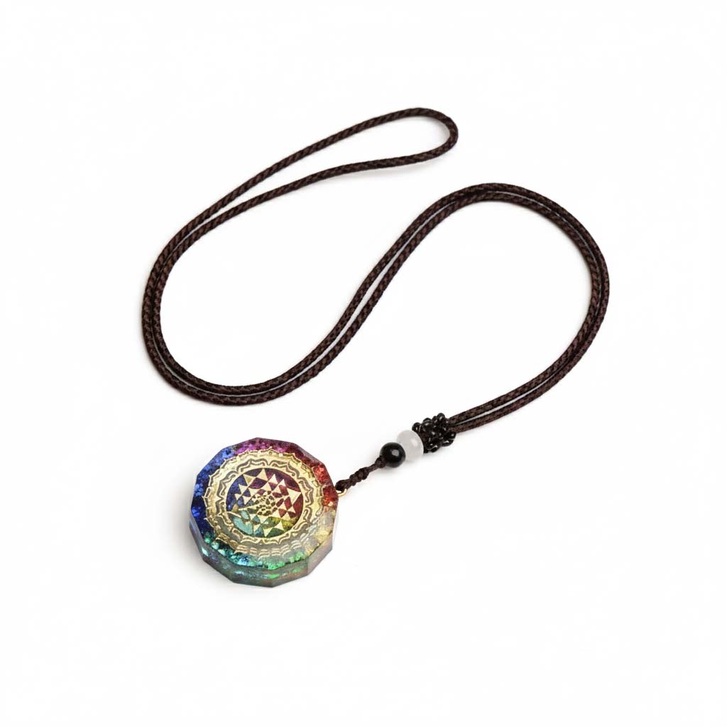 Close-up of golden Sri Yantra sacred geometry pattern on layered resin pendant showing intricate triangular design