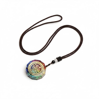 Close-up of golden Sri Yantra sacred geometry pattern on layered resin pendant showing intricate triangular design