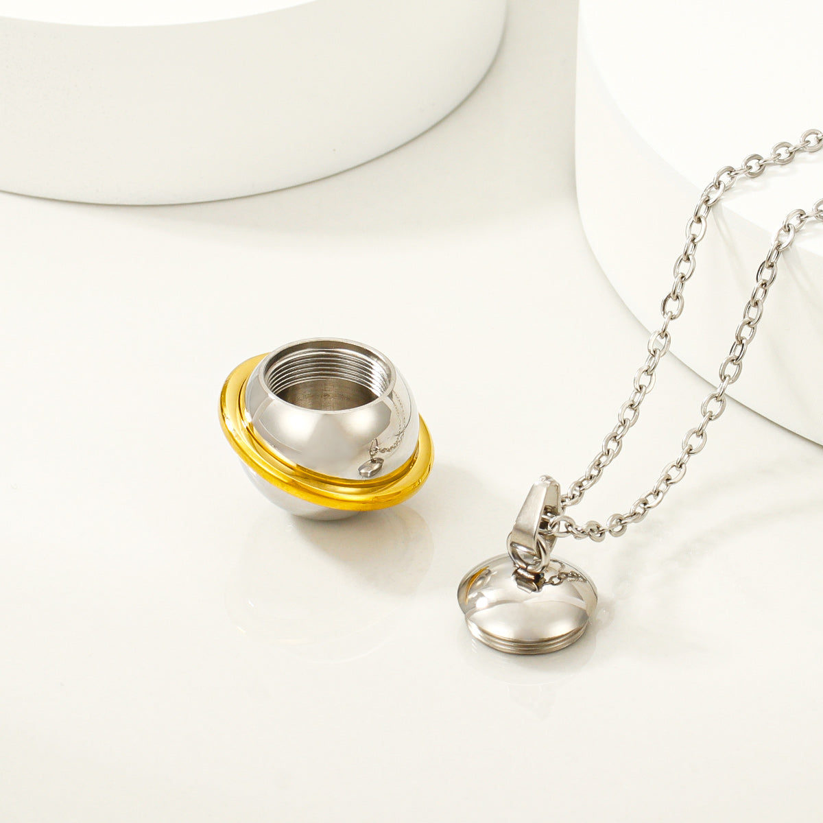 Open stainless steel keepsake pendant showing threaded compartment detail
