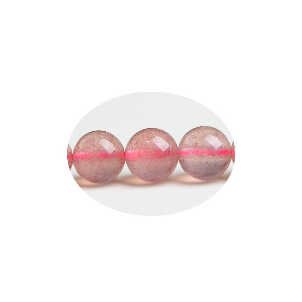 Close-up of Strawberry Quartz beads showing red spotted inclusions like strawberry seeds