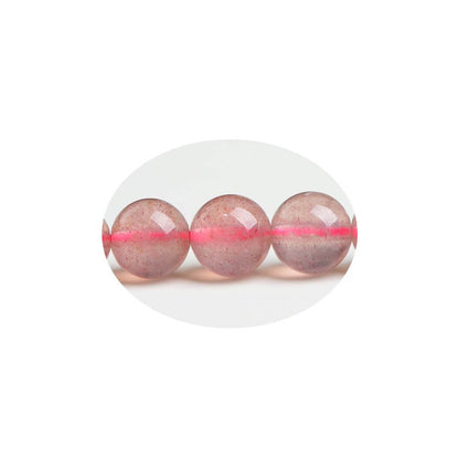 Close-up of Strawberry Quartz beads showing red spotted inclusions like strawberry seeds