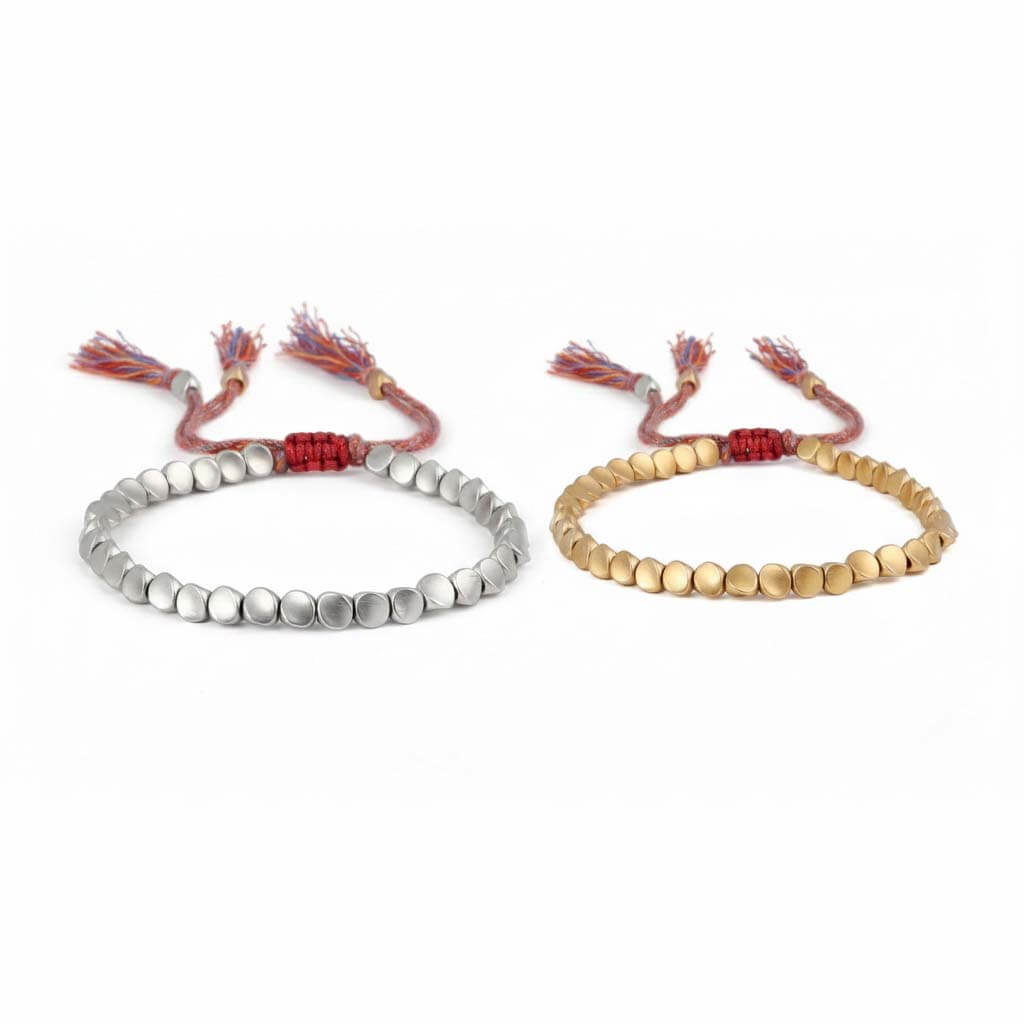 Handmade Tibetan beads bracelet showing two finishes side by side gold tone on right and silver tone on left with colorful braided cord and tassels