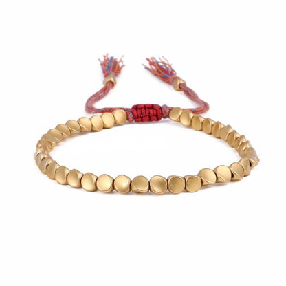 Handmade Tibetan metal beads bracelet in gold tone with colorful braided cord and decorative tassels