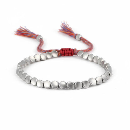Handmade Tibetan metal beads bracelet in silver tone with colorful braided cord and decorative tassels