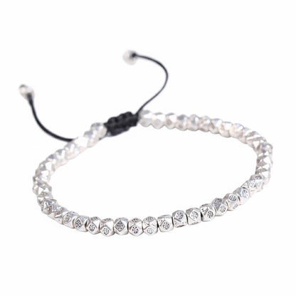 Tibetan faceted copper beads bracelet in silver tone with hand-engraved Buddhist mantra symbols on black cord