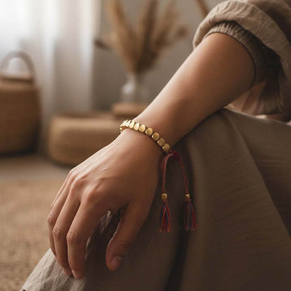 Person wearing gold tone Tibetan beads bracelet on wrist showing adjustable fit and bohemian style