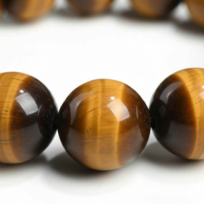 Close-up of Tiger Eye beads showing chatoyancy cat's eye effect and fibrous bands