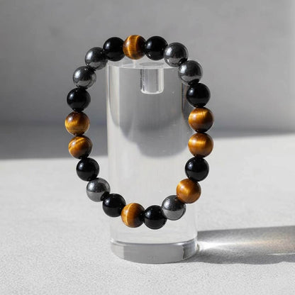 Tiger eye magnetic and agate bracelet displayed on jewelry stand showcasing chatoyant shimmer in natural light