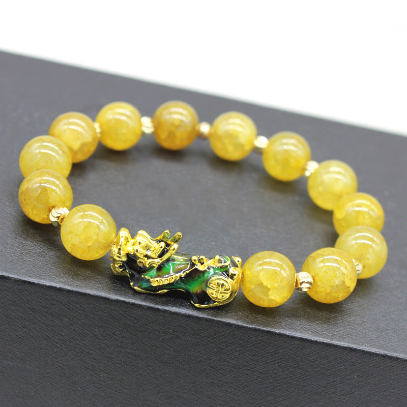 Feng Shui wealth bracelet featuring Amethyst, Aquamarine, and Rose Quartz with Pixiu charm for attracting prosperity