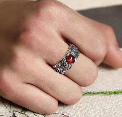 Person wearing natural garnet Pixiu ring on finger showing adjustable fit and red stone