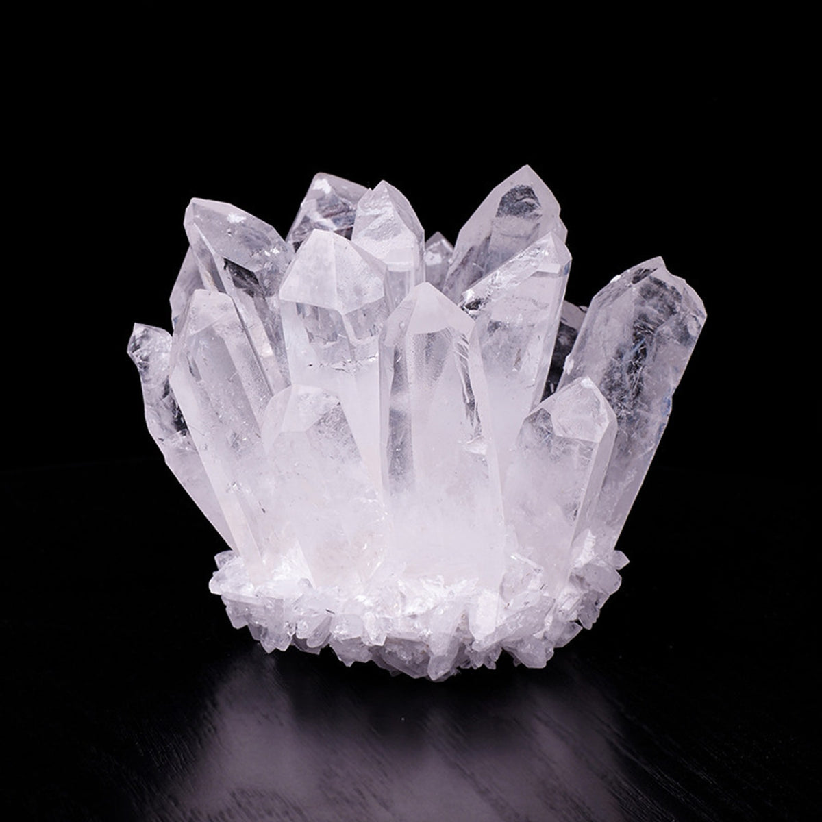 White quartz crystal cluster decor on black display surface
