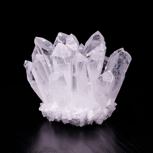 White quartz crystal cluster decor on black display surface