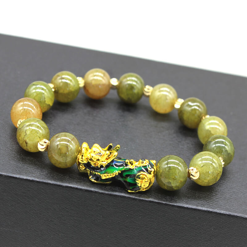 Yellow-green color-changing Pixiu bracelet with synthetic thermochromic beads showing olive to golden hues and gold-plated enamel Pixiu ornament with coin motifs